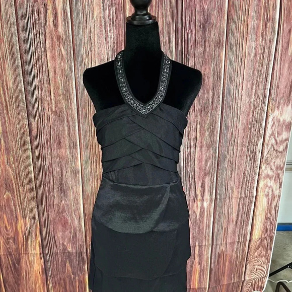 A cute little black dress by Trixxi with a halter neckline!   This dress is a ju - Picture 1 of 5